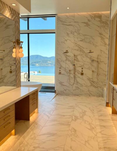 luxury marble bathroom with window view of lake