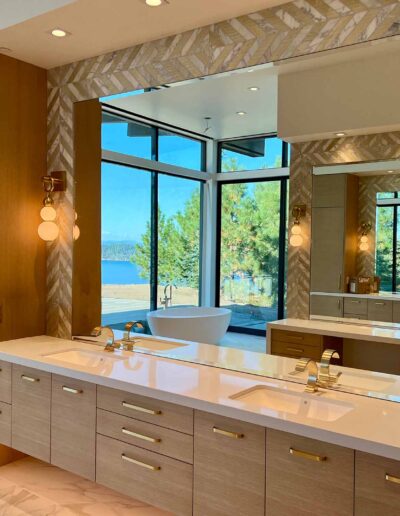 expansive bathroom with grey marble floors and white counters