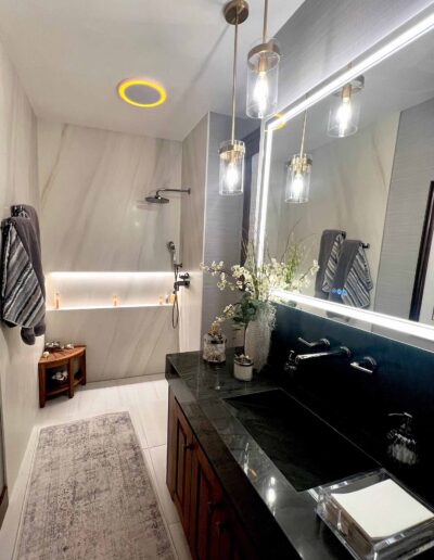 white marble shower and black marble sink