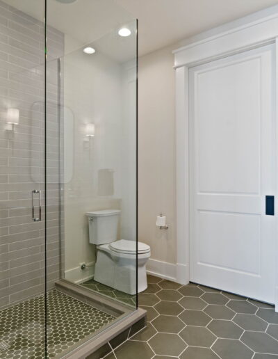 luxury tile walk-in shower and grey quartz sink countertop
