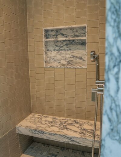 custom grey tile and marble shower with insert