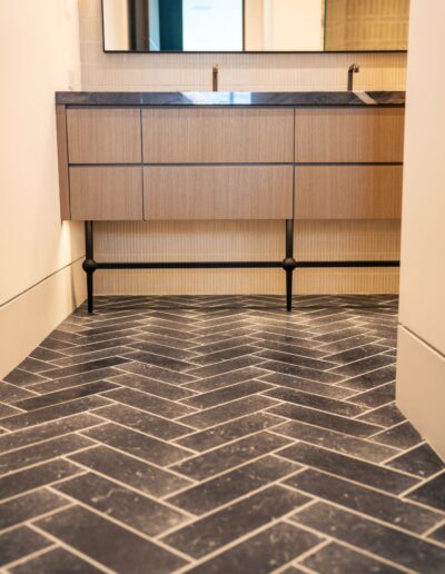 custom modern bathroom sinks with marble counters and black tile floors