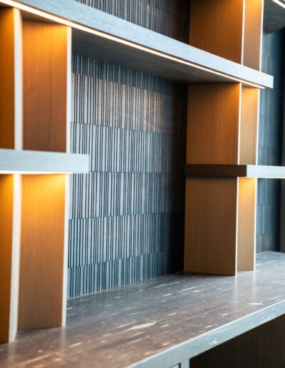 custom illuminated shelving with tile and marble