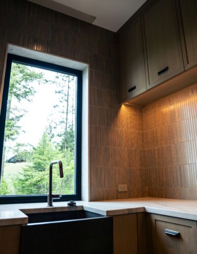 custom modern kitchen with illuminated cabinets and tile